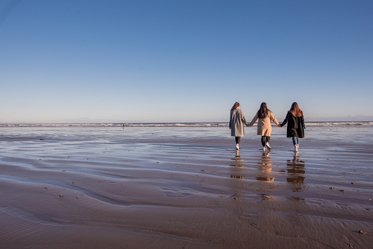 students walking on the beach